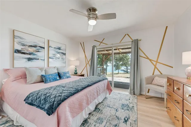 a bedroom with a large bed and a window