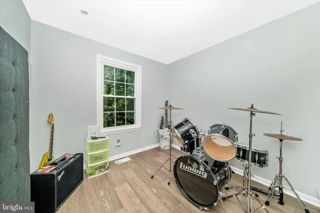 a living room with furniture a flat screen tv and a window