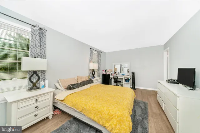 a bedroom with a bed and a night stand