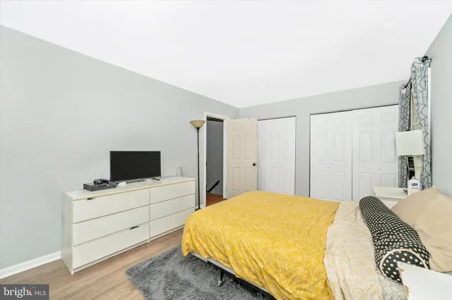 a bathroom with a sink a toilet a mirror and shower curtain