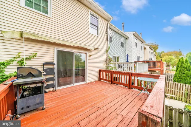 a view of backyard with a deck and wooden floor