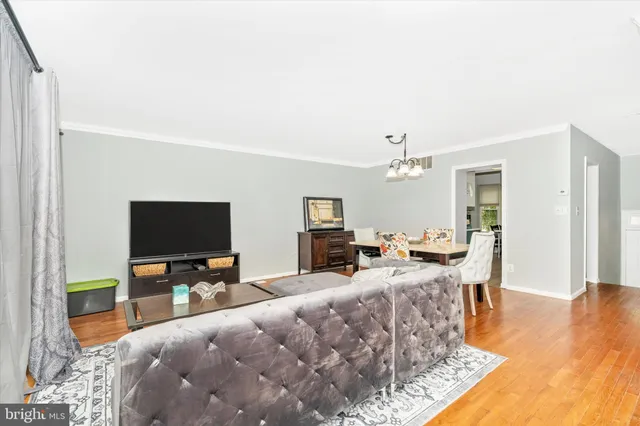 a living room with fireplace furniture and a flat screen tv