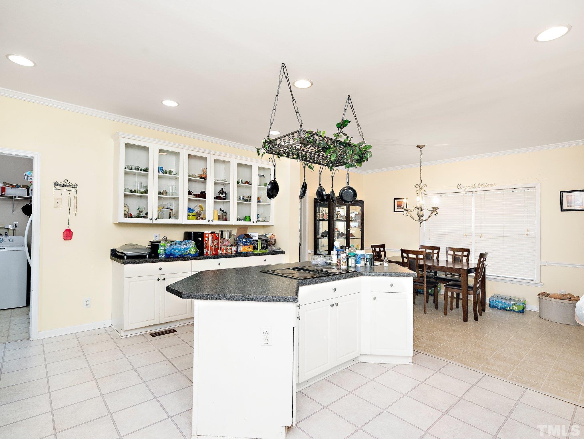 5169 Crabtree Road Nashville, NC 27856 - Photo 6 of 18 a kitchen with kitchen island granite countertop a sink and white cabinets
