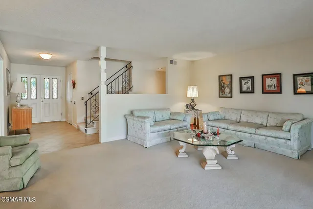 a dining room with furniture window and outside view
