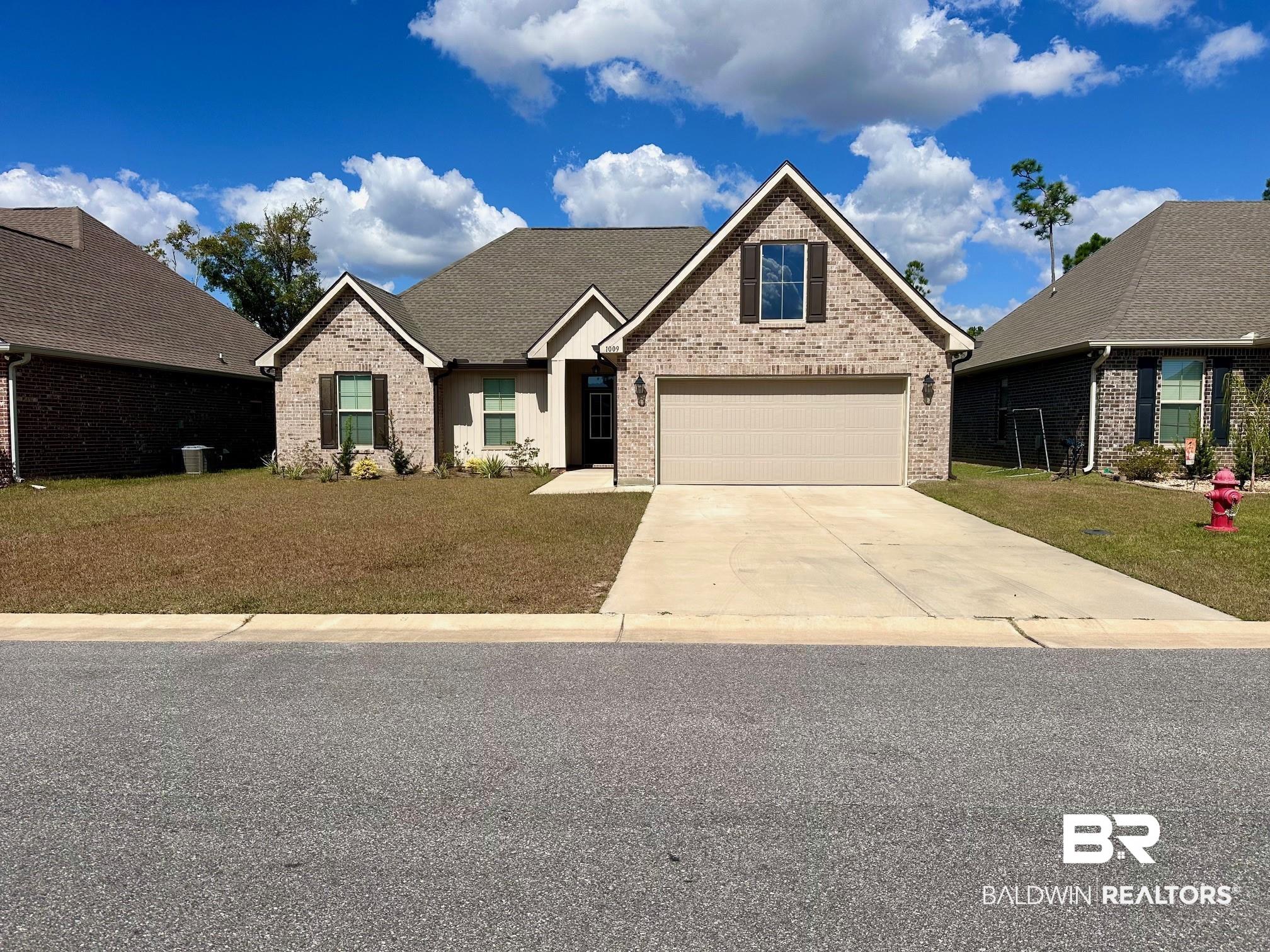1009 Ruisseau Drive Foley, AL 36535 - Photo 2 of 55 View of front facade with a garage and a front lawn