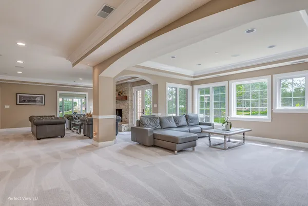 a living room with furniture and large windows