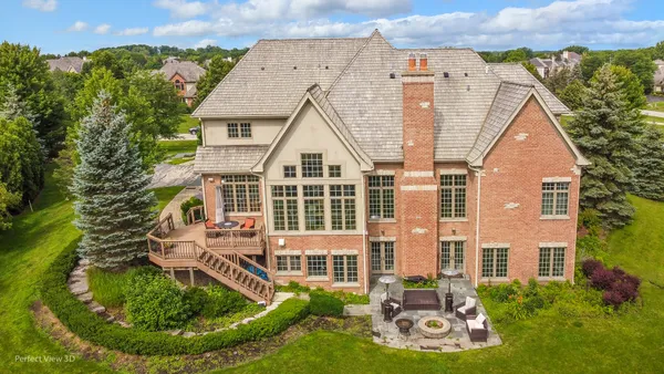 an aerial view of a house with swimming pool and garden