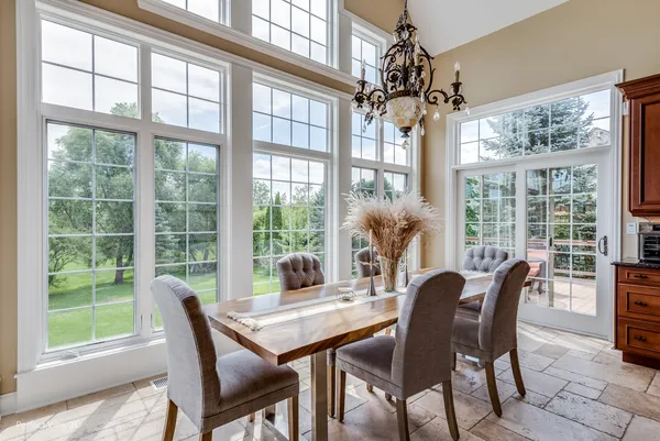 a view of a dining room with furniture large windows and wooden floor