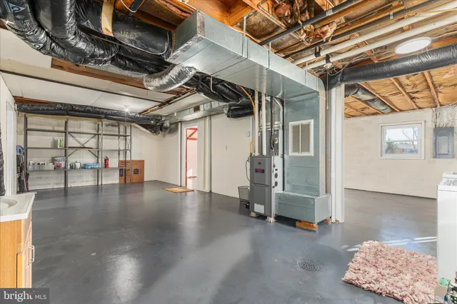 a view of empty room with wooden floor and windows