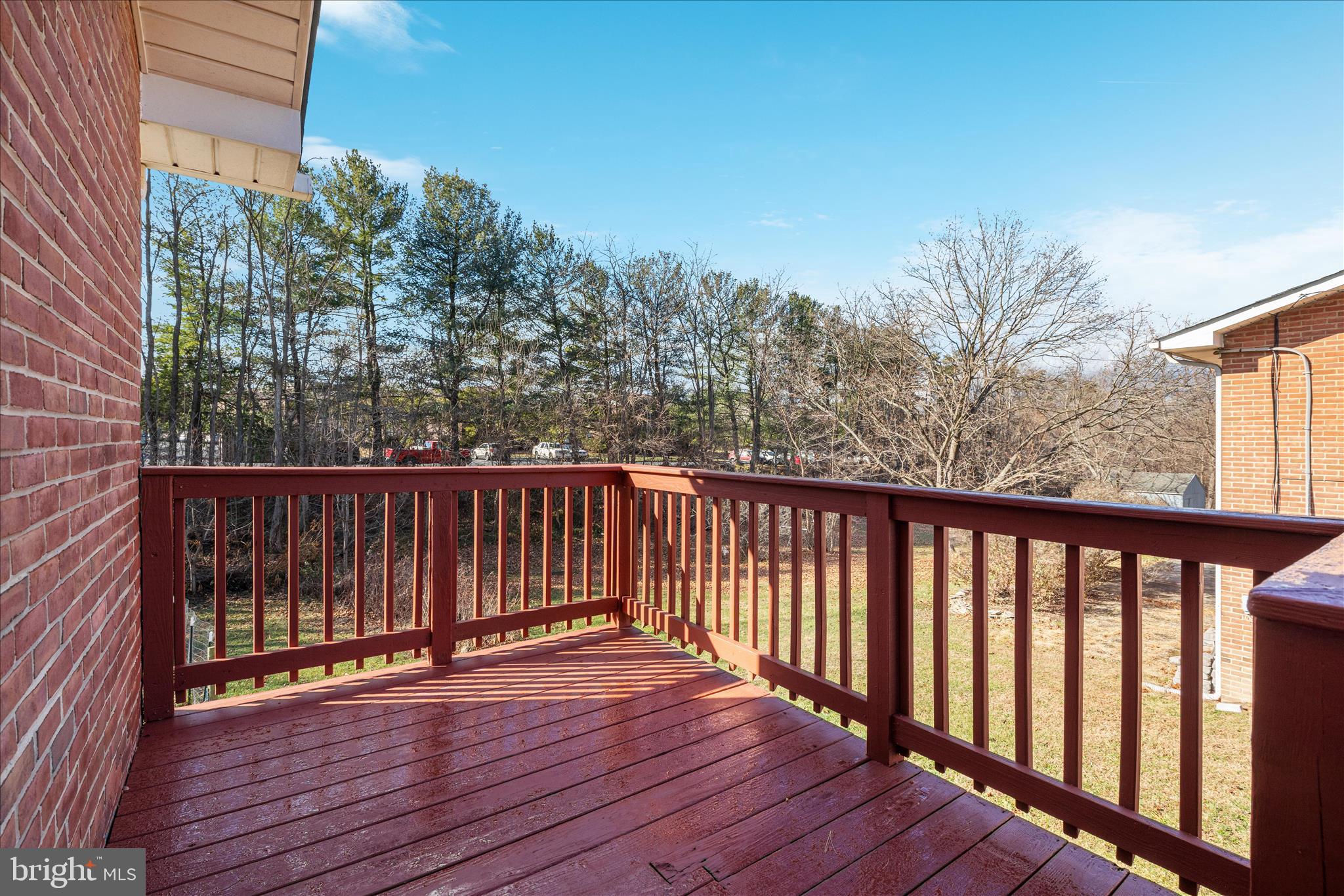 113 Williamson Road Winchester, VA 22602 - Photo 29 of 52 a balcony with wooden floor and trees in the back