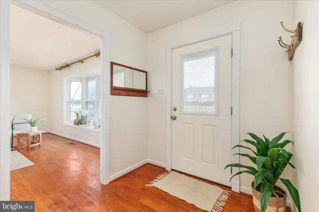 a view of a livingroom with wooden floor and a potted plant