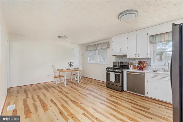 a kitchen with a stove a sink and a refrigerator