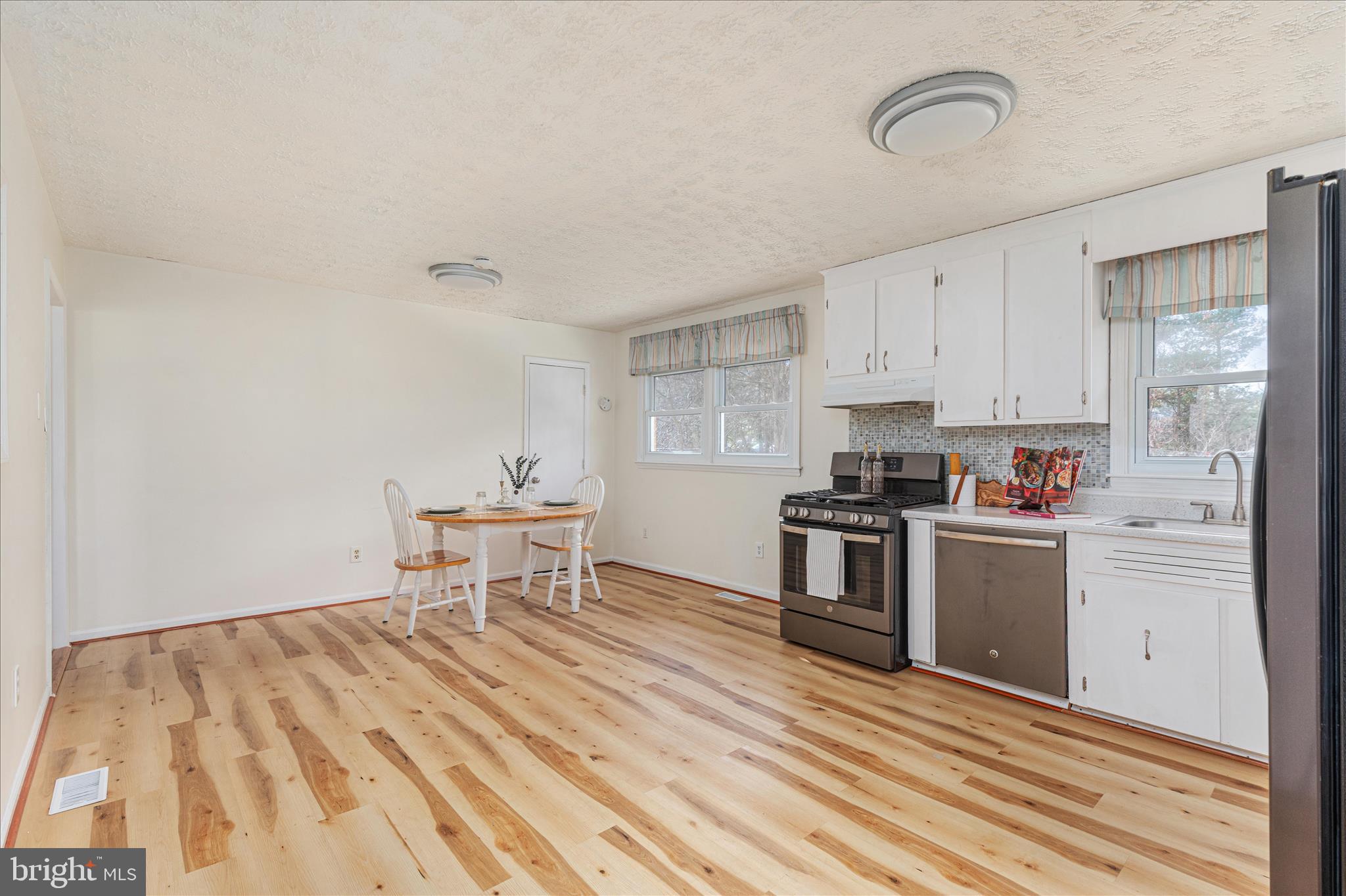113 Williamson Road Winchester, VA 22602 - Photo 4 of 52 a kitchen with a stove a sink and a refrigerator