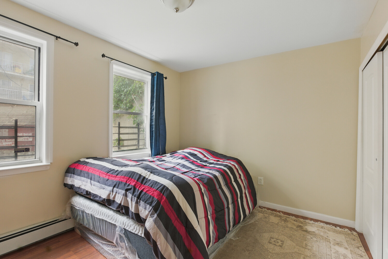 2517 Boston Road Bronx, NY 10467 - Photo 3 of 11 a bedroom with a bed and a window