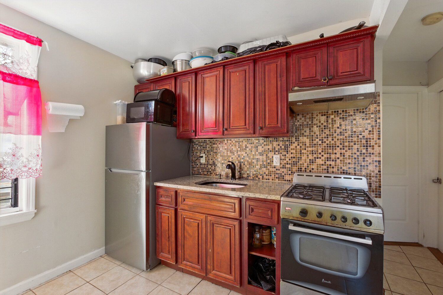 2517 Boston Road Bronx, NY 10467 - Photo 5 of 11 a kitchen with stainless steel appliances a stove a refrigerator and wooden cabinets