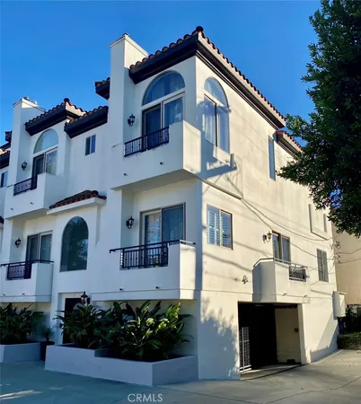 a front view of a house with plants