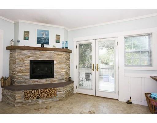 349 Brook Street Dighton, MA 02715 - Photo 5 of 25 a living room with a fireplace furniture a rug and a window