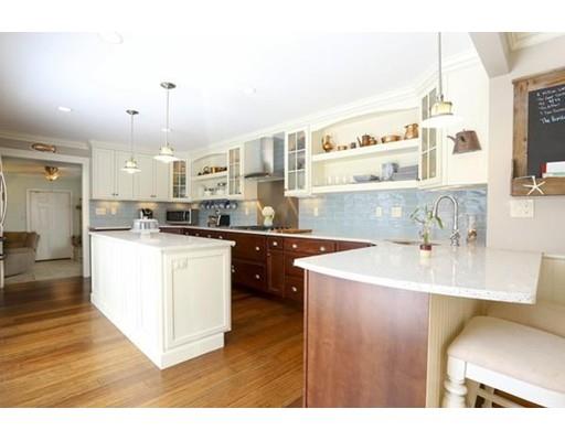 349 Brook Street Dighton, MA 02715 - Photo 8 of 25 a kitchen with kitchen island a sink a stove a refrigerator and a dining table with wooden floor
