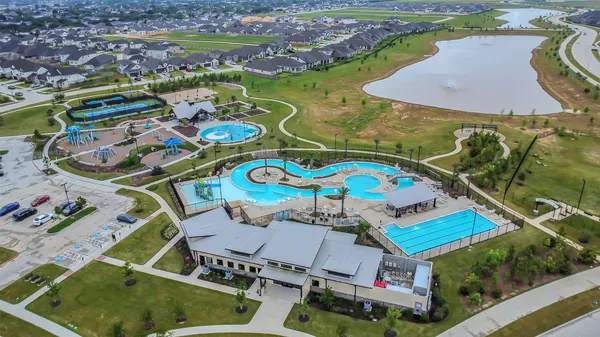 an aerial view of a pool patio yard and lake view