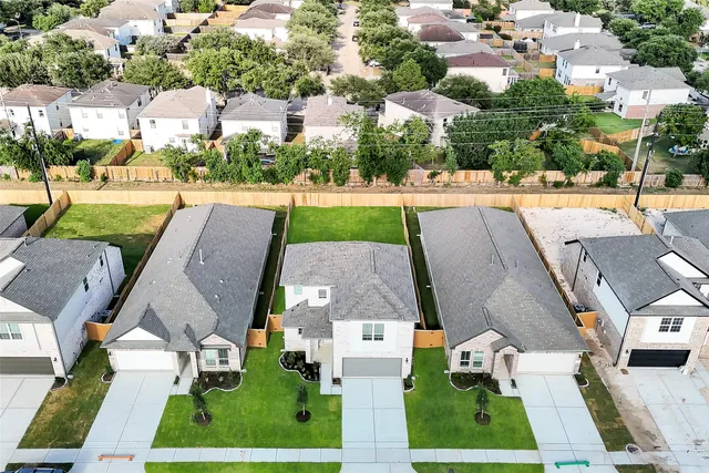 an aerial view of a house with a yard and lake view