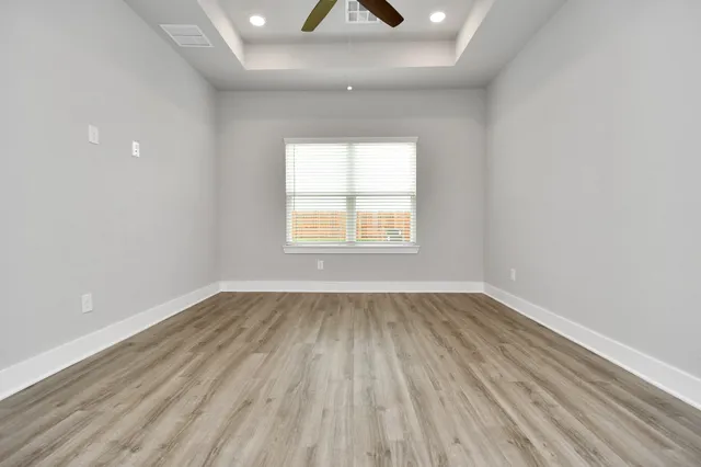 wooden floor in an empty room with a window