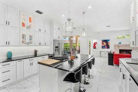 a kitchen that has a lot of cabinets in it and a sink
