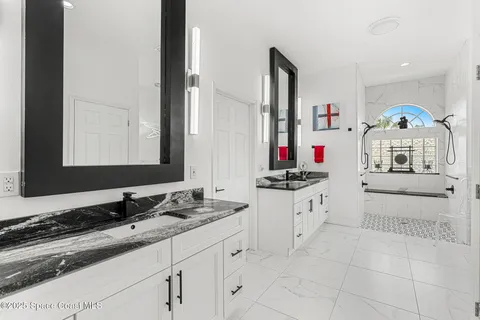 a bathroom with a sink vanity and a mirror