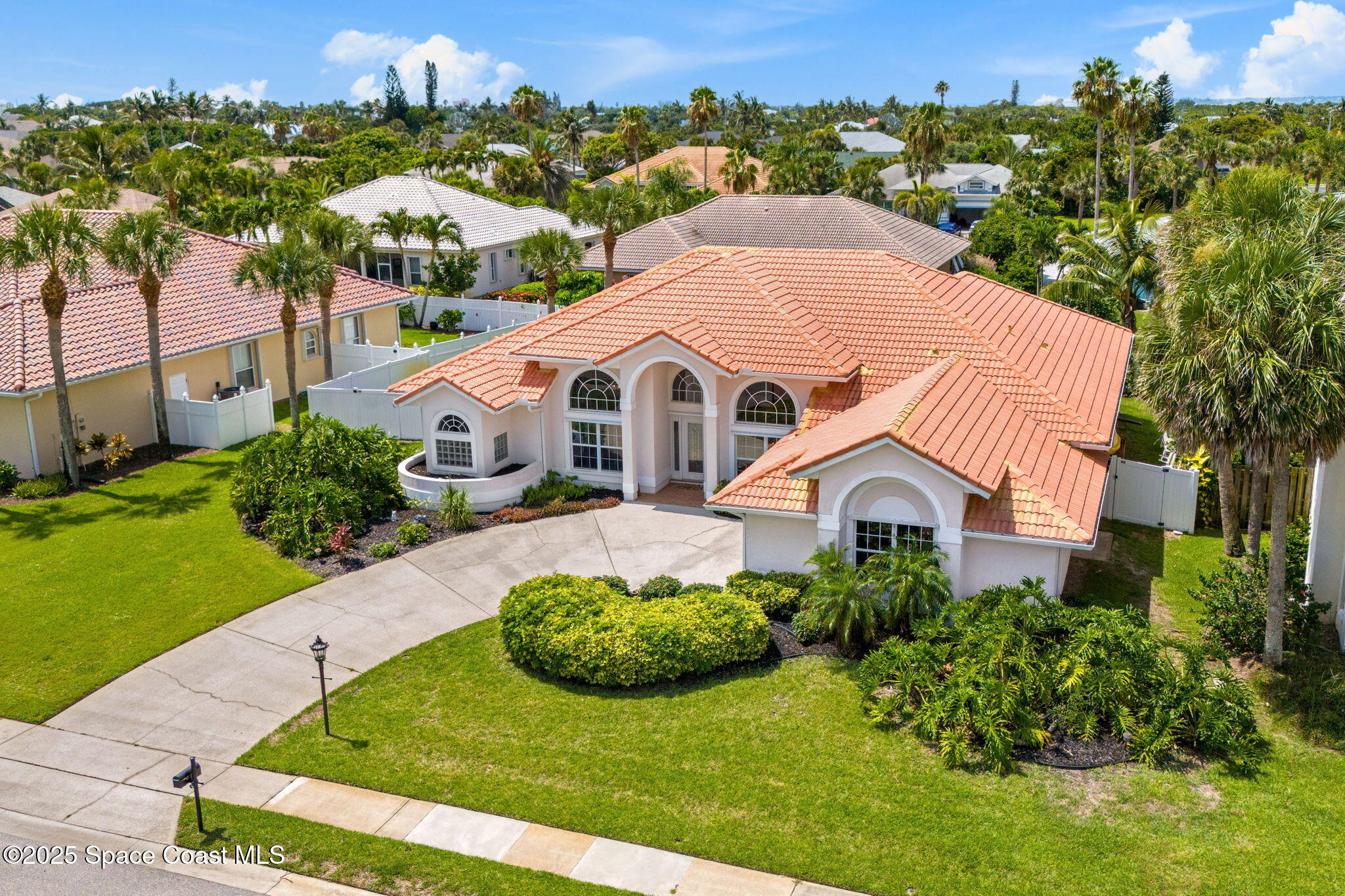 227 Loggerhead Drive Melbourne Beach, FL 32951 - Photo 2 of 52 a view of a white house with a big yard plants and large trees