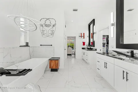 a spacious bathroom with a double vanity sink and a mirror