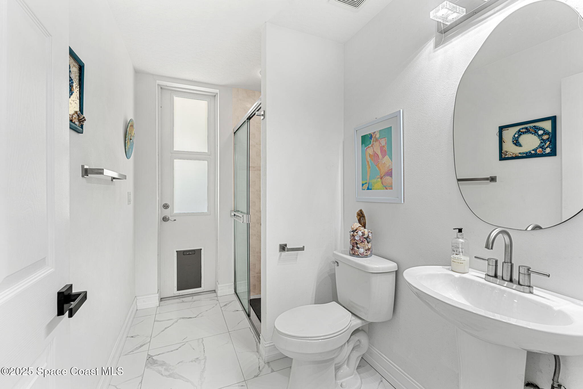 227 Loggerhead Drive Melbourne Beach, FL 32951 - Photo 25 of 52 a bathroom with a sink toilet and shower