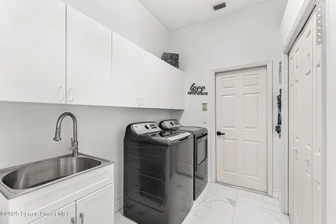 a kitchen with stainless steel appliances granite countertop a sink and a refrigerator