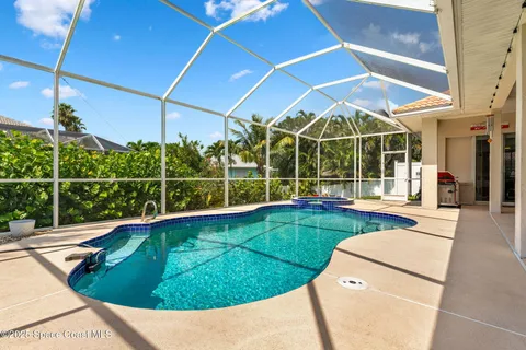 a view of a backyard with swimming pool