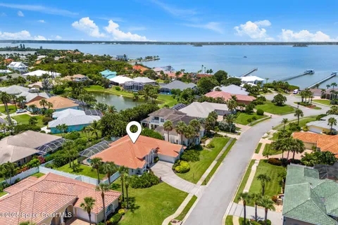 an aerial view of a house with a lake view
