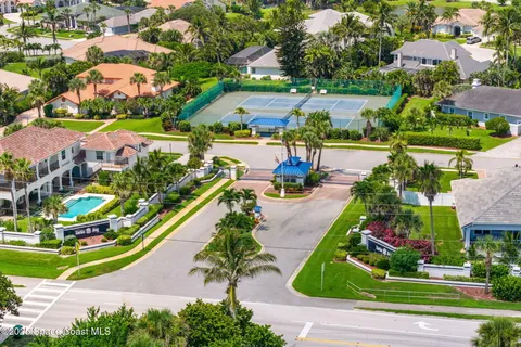 an aerial view of residential houses with yard and lake view