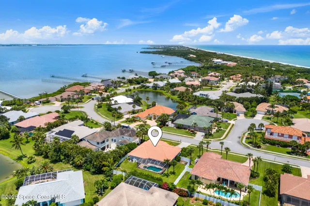 an aerial view of residential houses with outdoor space and street view