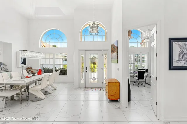a living room with furniture and a chandelier