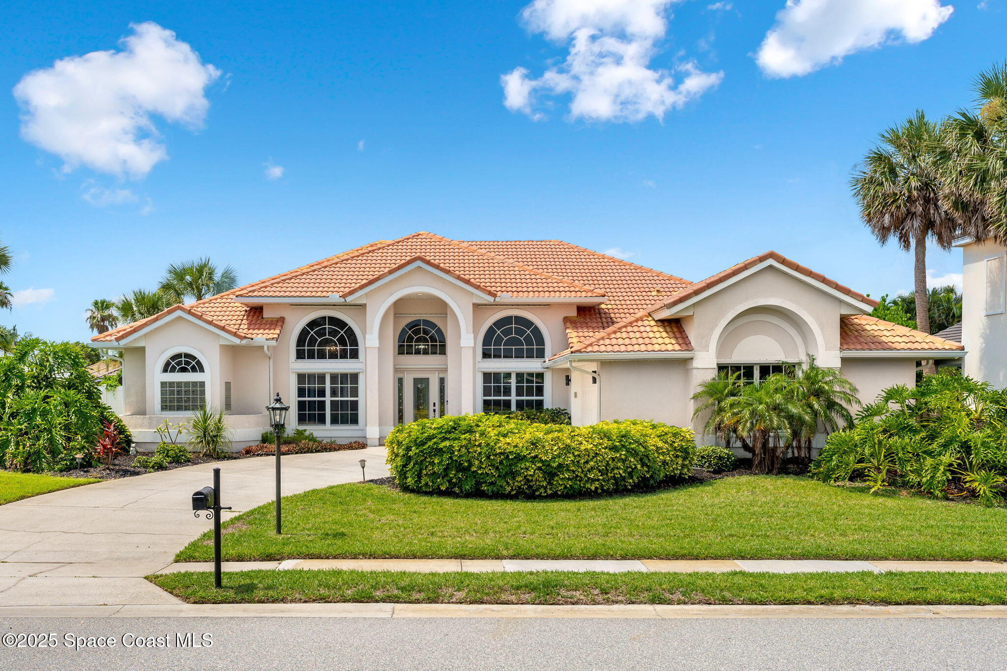 227 Loggerhead Drive Melbourne Beach, FL 32951 - Photo 51 of 52 a front view of a house with a yard and garage