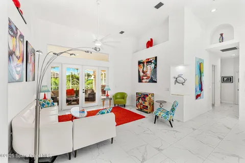 a living room with furniture and a baby crib