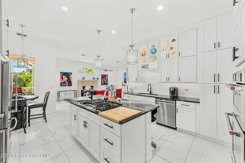 a kitchen with granite countertop a sink stove and cabinets