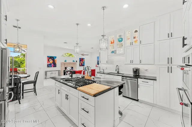 a kitchen with granite countertop a sink stove and cabinets