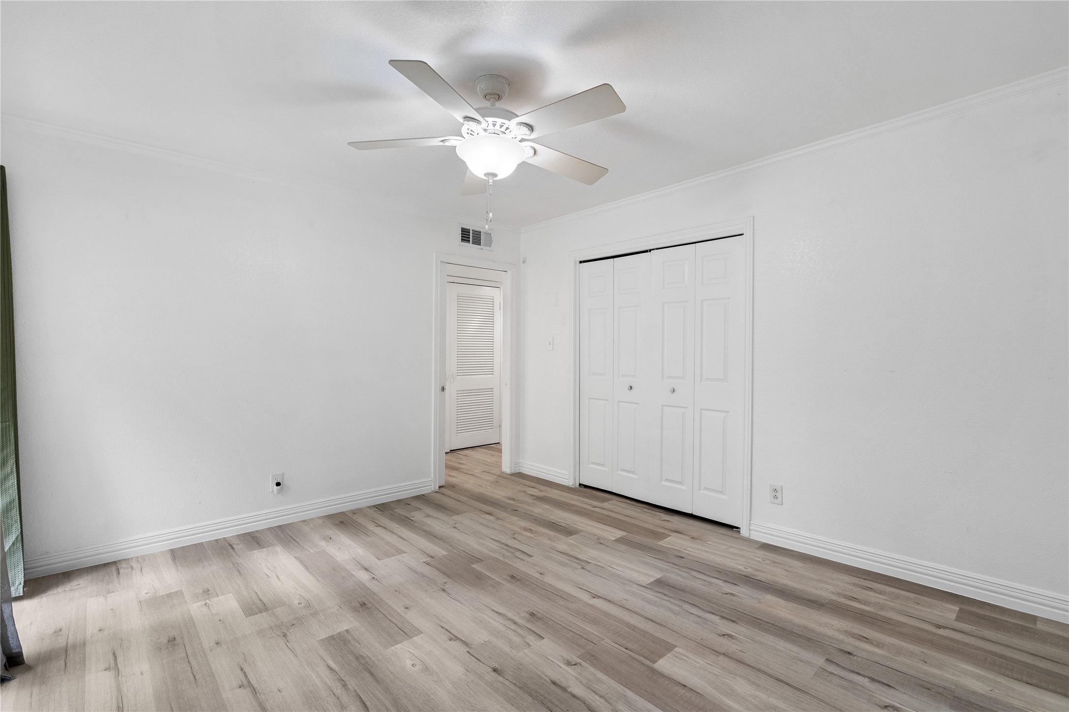 6303 Crab Orchard Road, Unit 3 Houston, TX 77057 - Photo 24 of 30 Looking back toward the entrance of the second bedroom, you can appreciate the consistent, high-end finish. The clean-lined baseboards and fresh white palette make this the perfect space for a guest room, a high-end nursery, or a quiet home office.