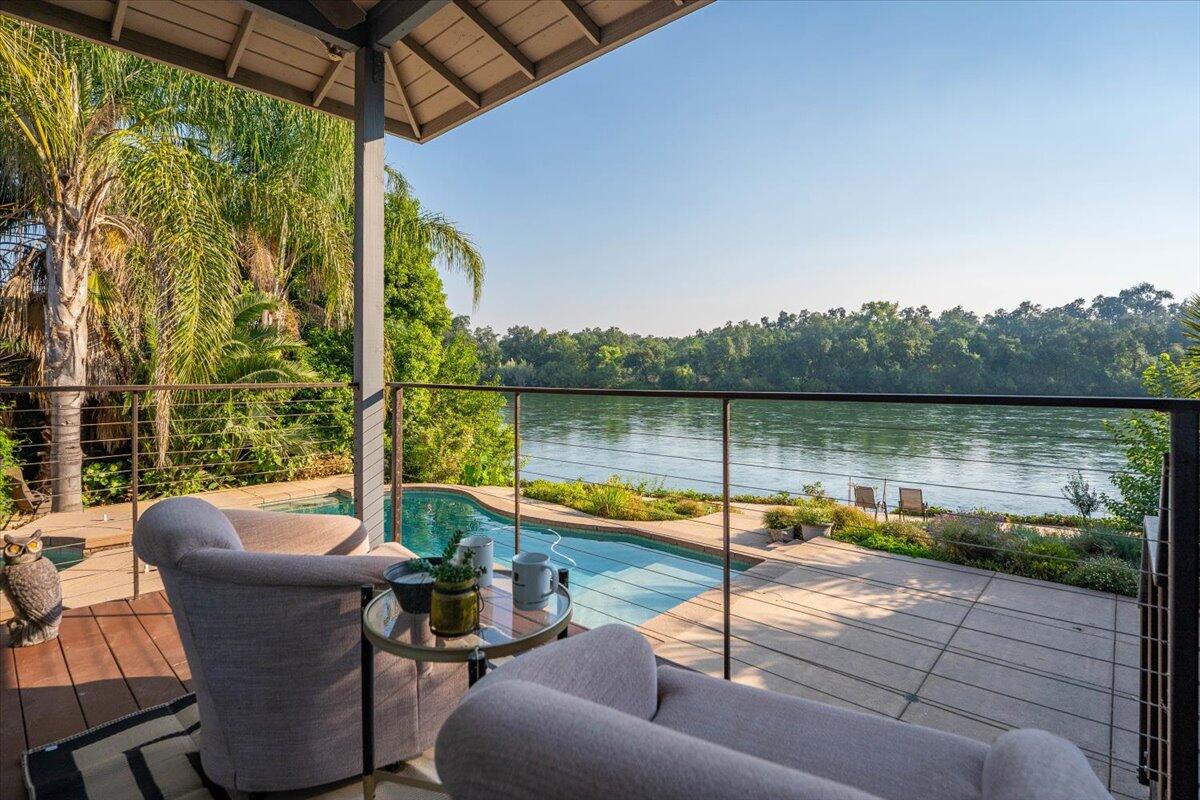 3301 Riverside Drive Anderson, CA 96007 - Photo 23 of 27 a view of a lake with couches and wooden floor