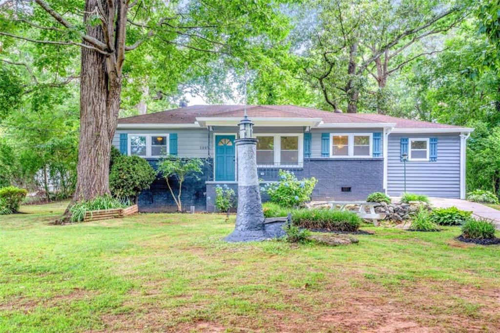 1005 Southwest Wilson Road Southwest Mableton, GA 30126 - Photo 1 of 1 a front view of a house with garden