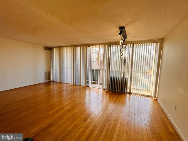 a view of wooden floor and brick walls