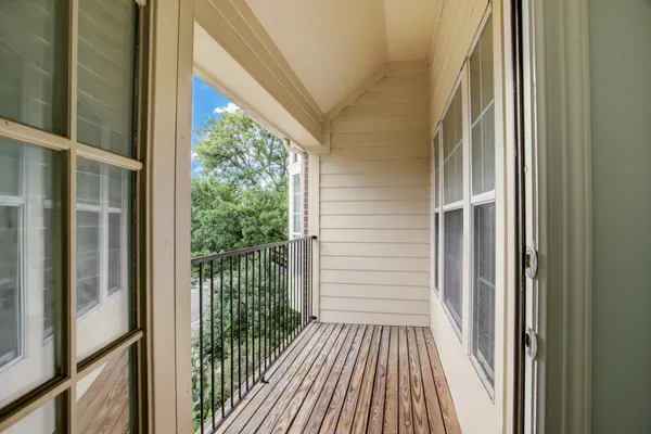 a view of a balcony with wooden floor