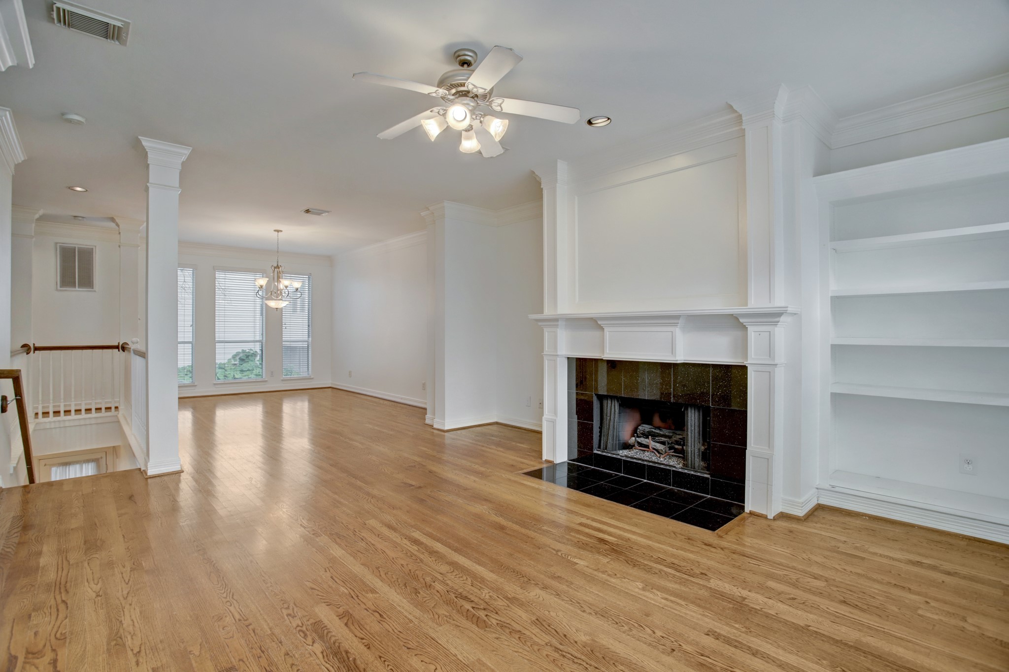 2205 Commonwealth Street Houston, TX 77006 - Photo 6 of 22 Living area looking into spacious dining room. Stairway leads down to two bedrooms, bathroom and laundry room.