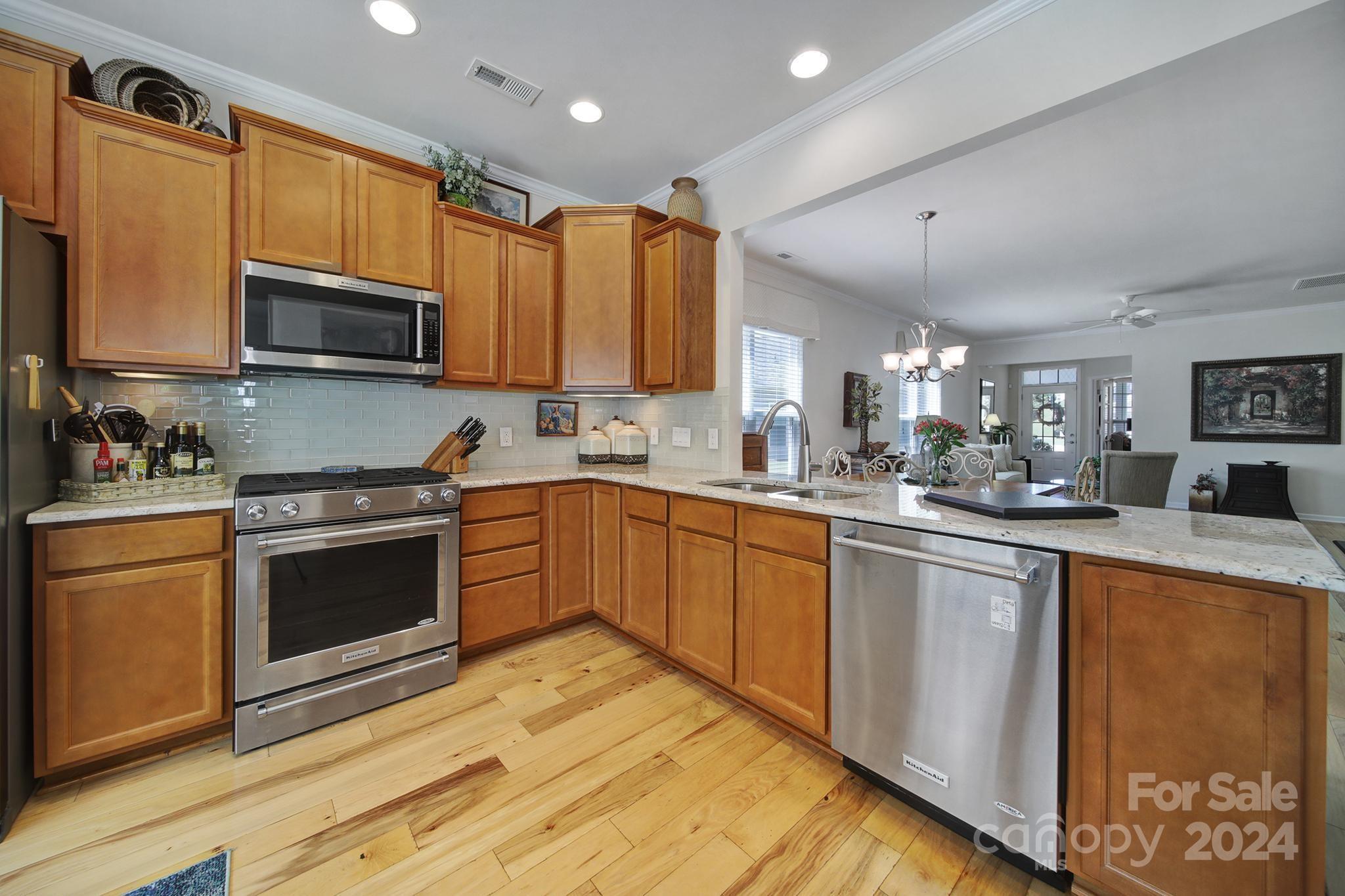 3055 Everett Lane Fort Mill, SC 29707 - Photo 11 of 40 a kitchen with stainless steel appliances granite countertop a stove a sink dishwasher and a microwave oven with cabinets