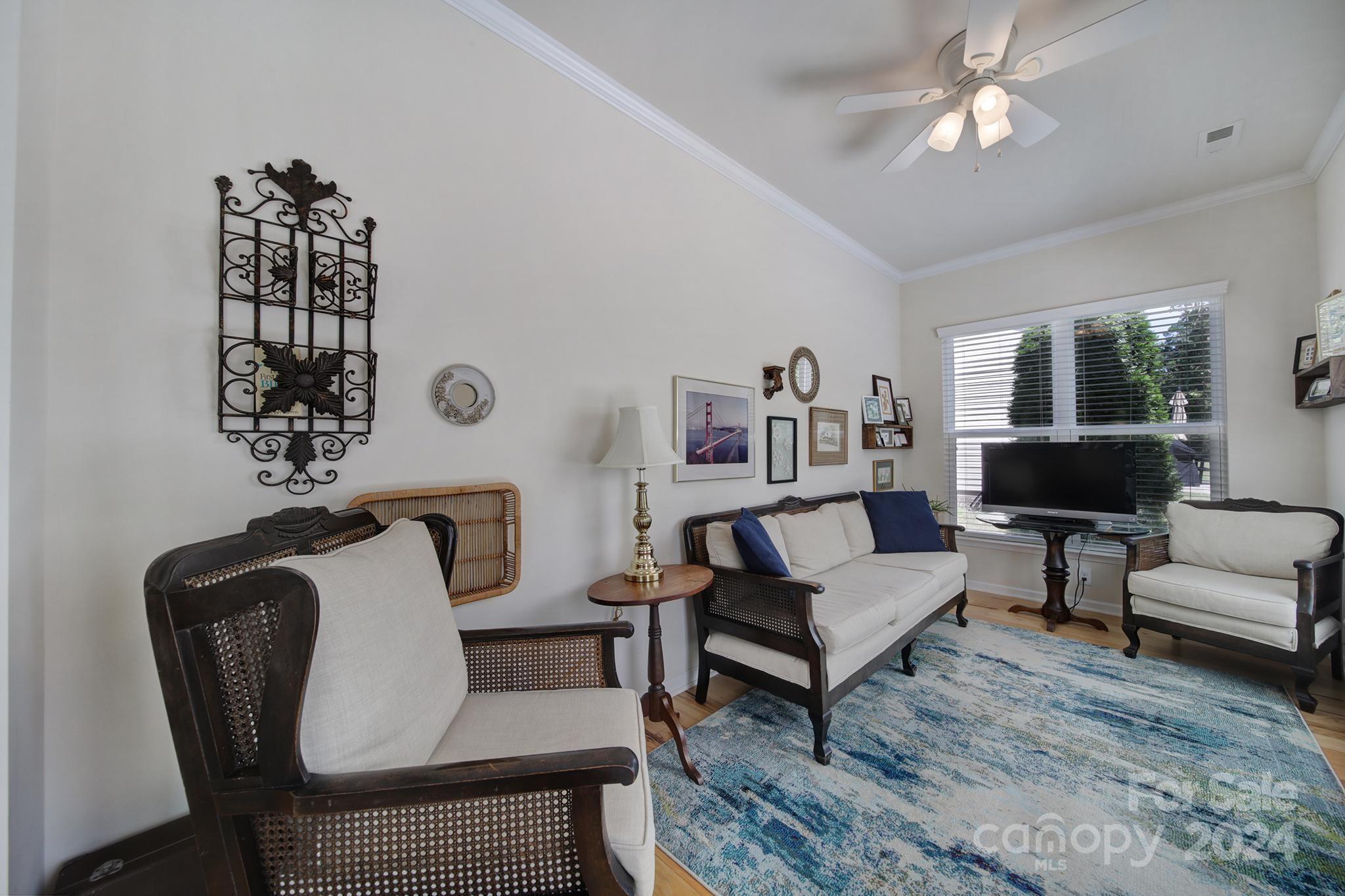 3055 Everett Lane Fort Mill, SC 29707 - Photo 14 of 40 a living room with furniture a chandelier and a rug