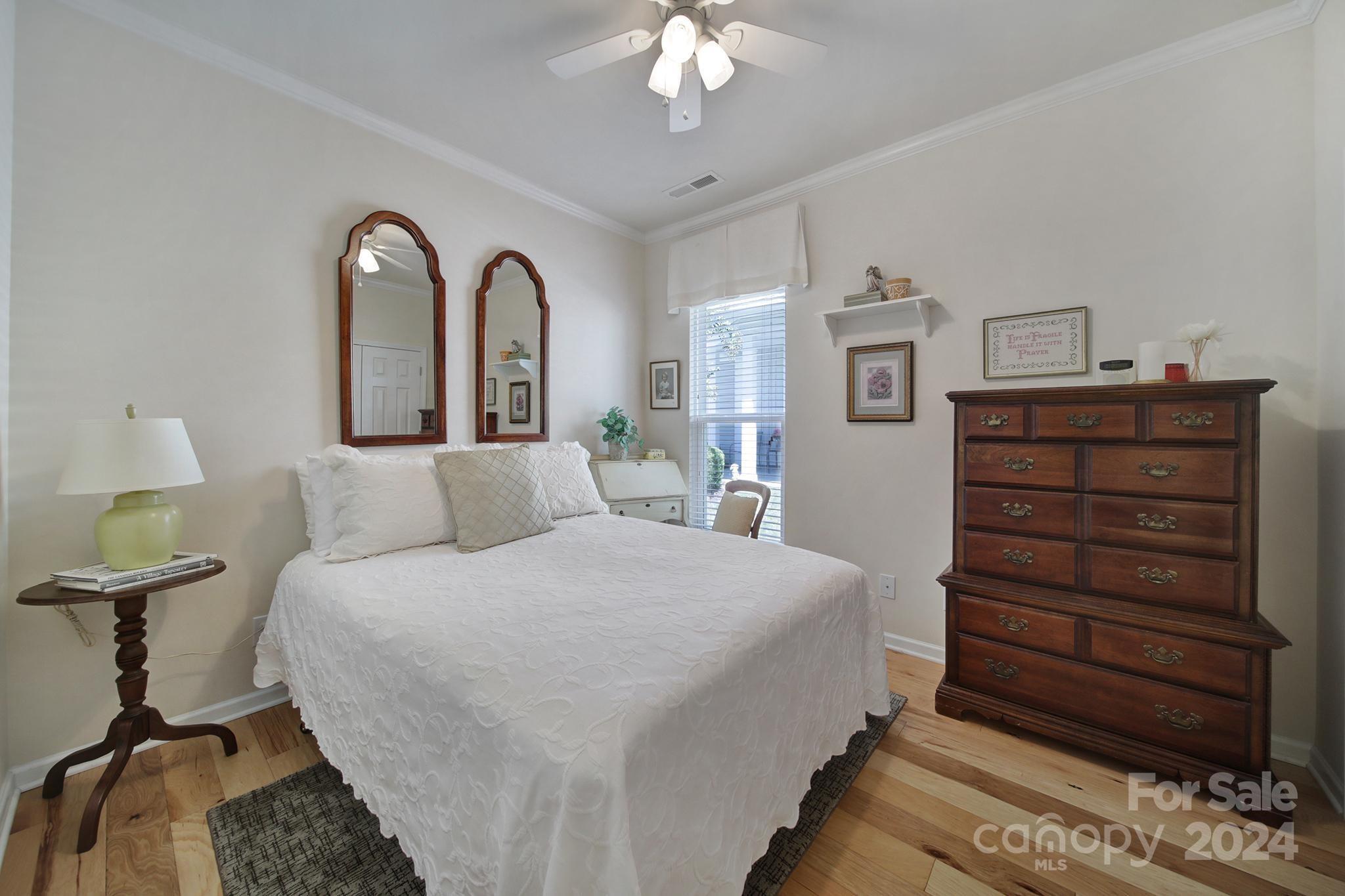 3055 Everett Lane Fort Mill, SC 29707 - Photo 21 of 40 a bedroom with a bed and a chandelier