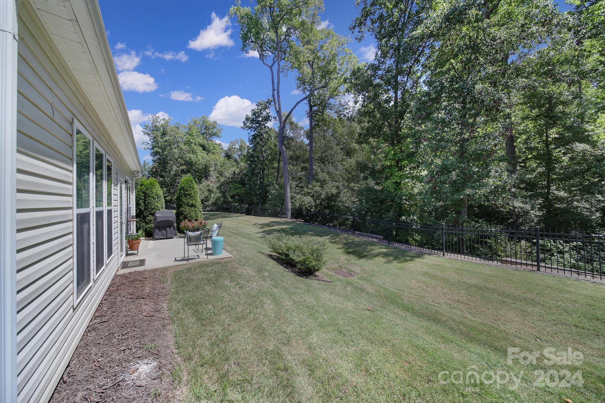 3055 Everett Lane Fort Mill, SC 29707 - Photo 24 of 40 a view of a chair and tables in the backyard of the house
